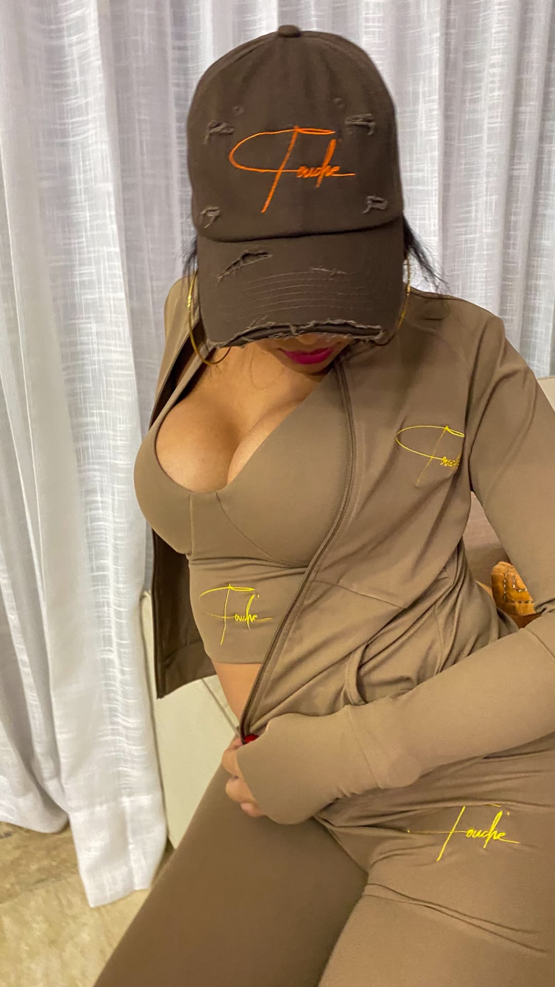 Espresso brown matching set with gold Touché script embroidery, worn with a distressed brown cap