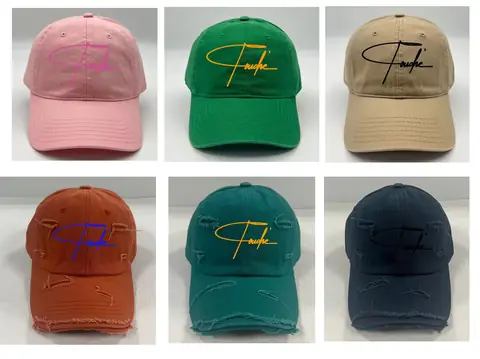 Six distressed Touché signature caps in rose, olive, sand, clay, teal, and navy