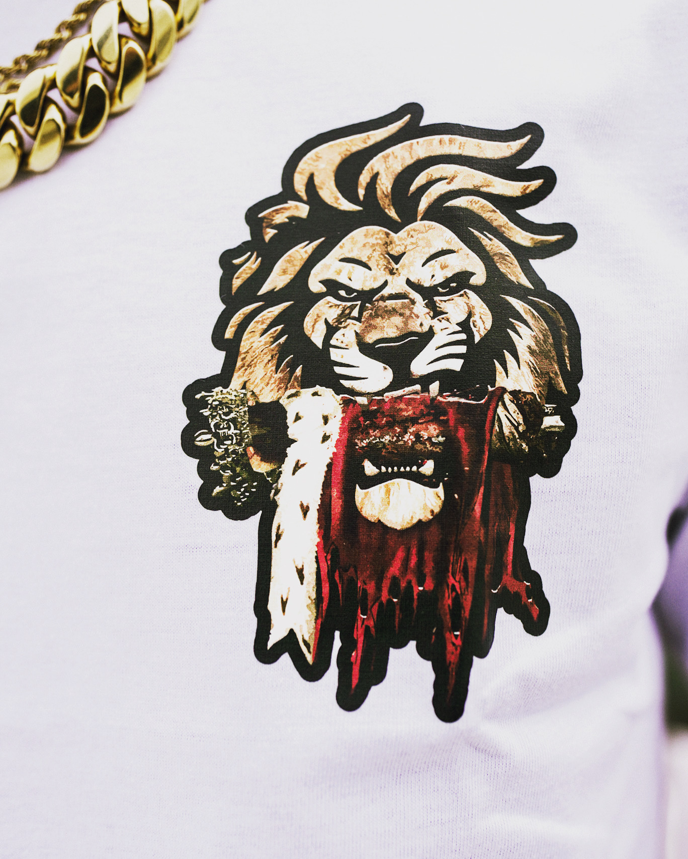Close detail of the gold and red crowned lion print on white cotton