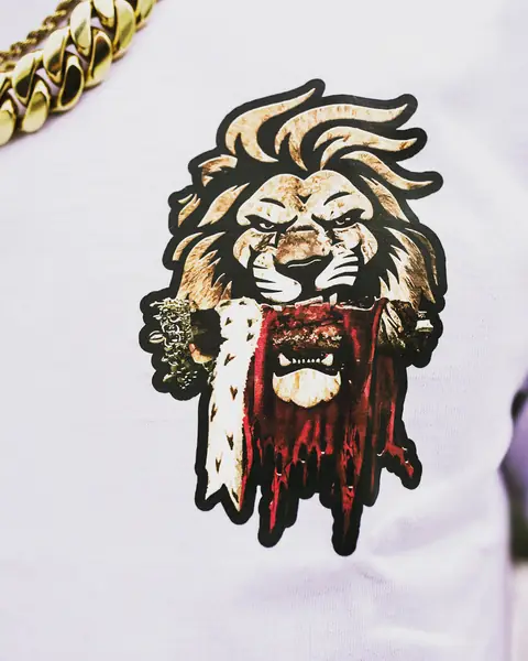 Close detail of the gold and red crowned lion print on white cotton